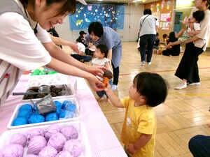 1歳児の子どもがアイスクリームを受け取っている写真