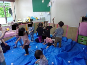 写真：ブルーシートが敷き詰められた部屋で遊ぶ子どもたち